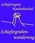Das Wegelogo ist blau. Oben steht in gelber Schrift "Schieferregion Kaulenbachtal" und im unteren Bereich "Schiefergrubenwanderweg". In der Mitte des Logo ist ein Förderturm in gelb gezeichnet.